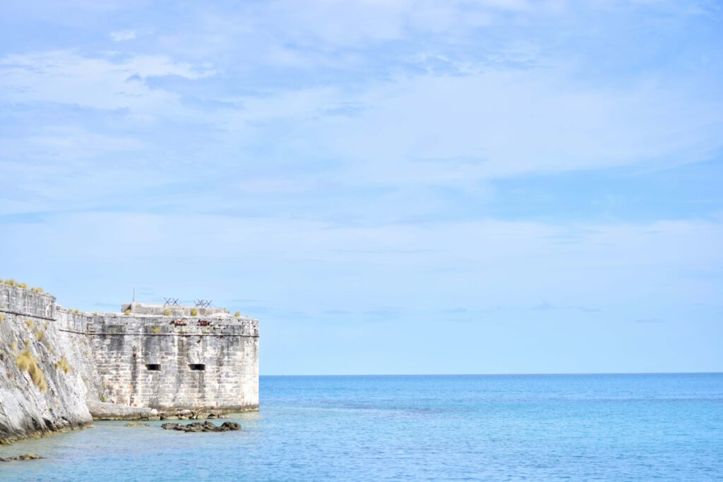View of King's Wharf in Royal Naval Dockyard, Bermuda featuring a historic building on the left side.